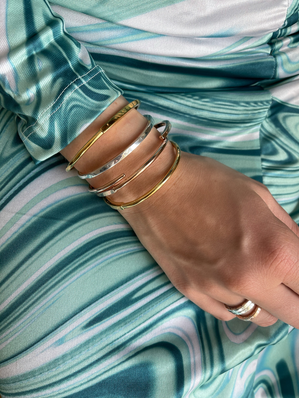 Keep things fresh with a stack of different metals to finish your Signature I-D bangle look